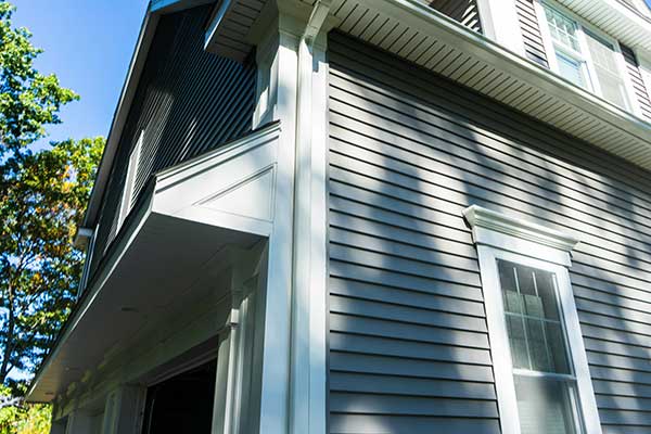 Looking up a home exterior with light blue siding