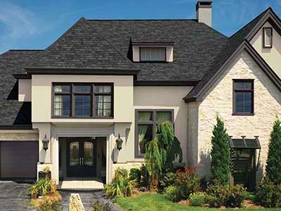 Front of a typical looking home with black GAF shingles on its roof